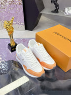 White and orange leather sneakers with lace-up design and molded rubber outsole