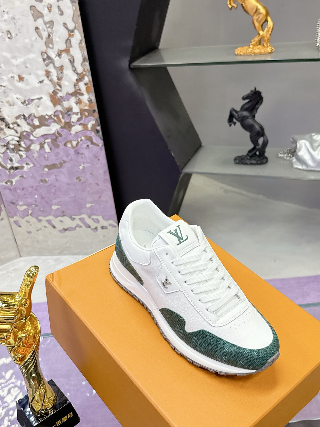 White and green lace-up sneaker with LV logo on tongue, side view