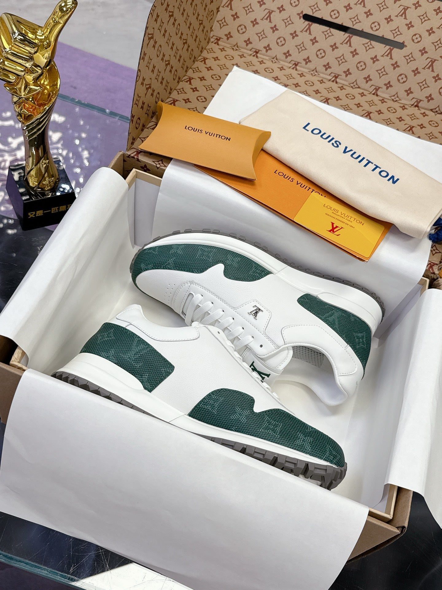 White and green low-top sneakers with lace-up front and textured side panel