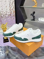 Pair of white and green lace-up sneakers with Louis Vuitton logo on tongue