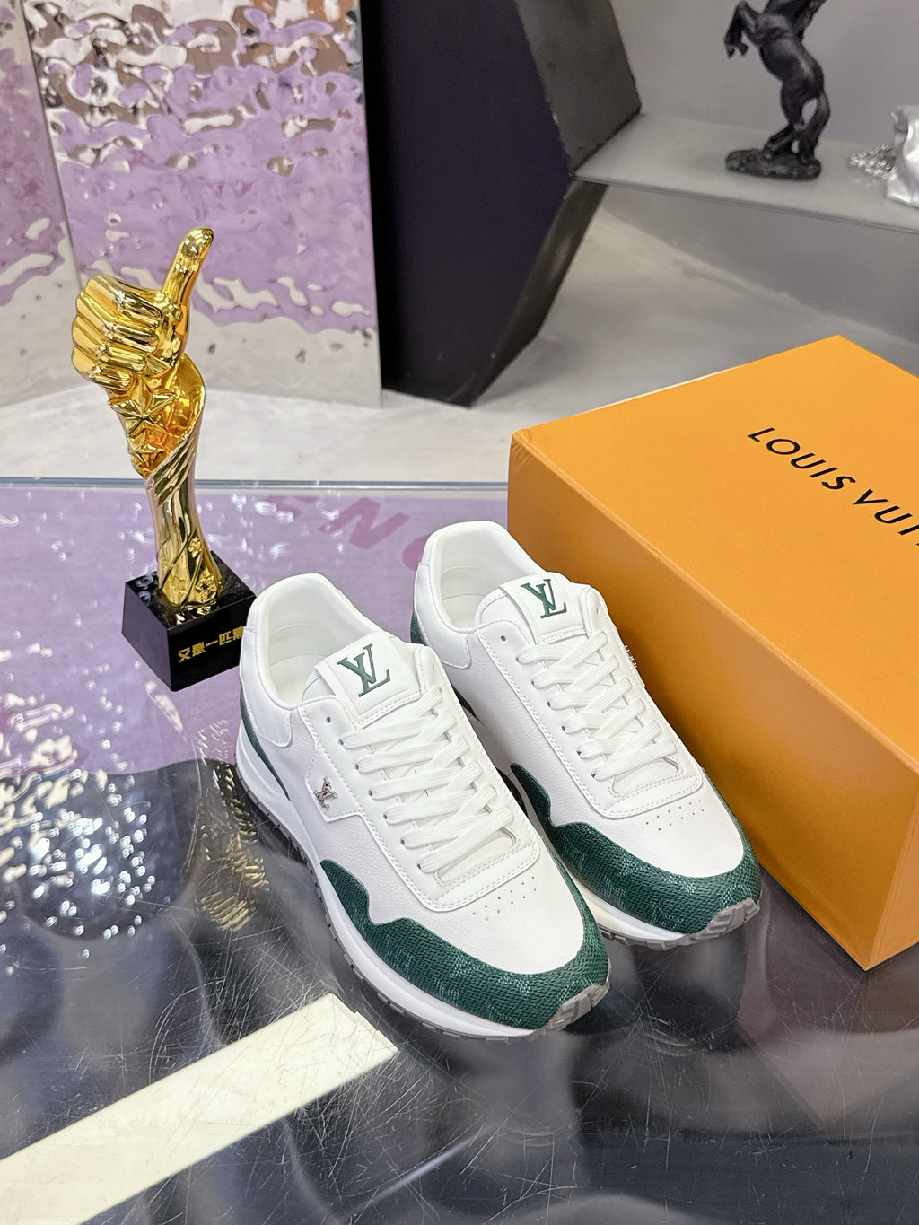White and green lace-up sneakers with Louis Vuitton logo, on display box
