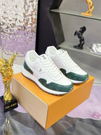 White and green lace-up sneakers on orange box, side view