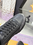 Louis Vuitton sneakers close-up: dark gray/black leather with lace-up detail