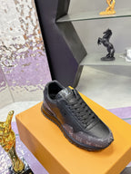 Louis Vuitton lace-up sneaker in dark gray/black monogram, angled on orange box