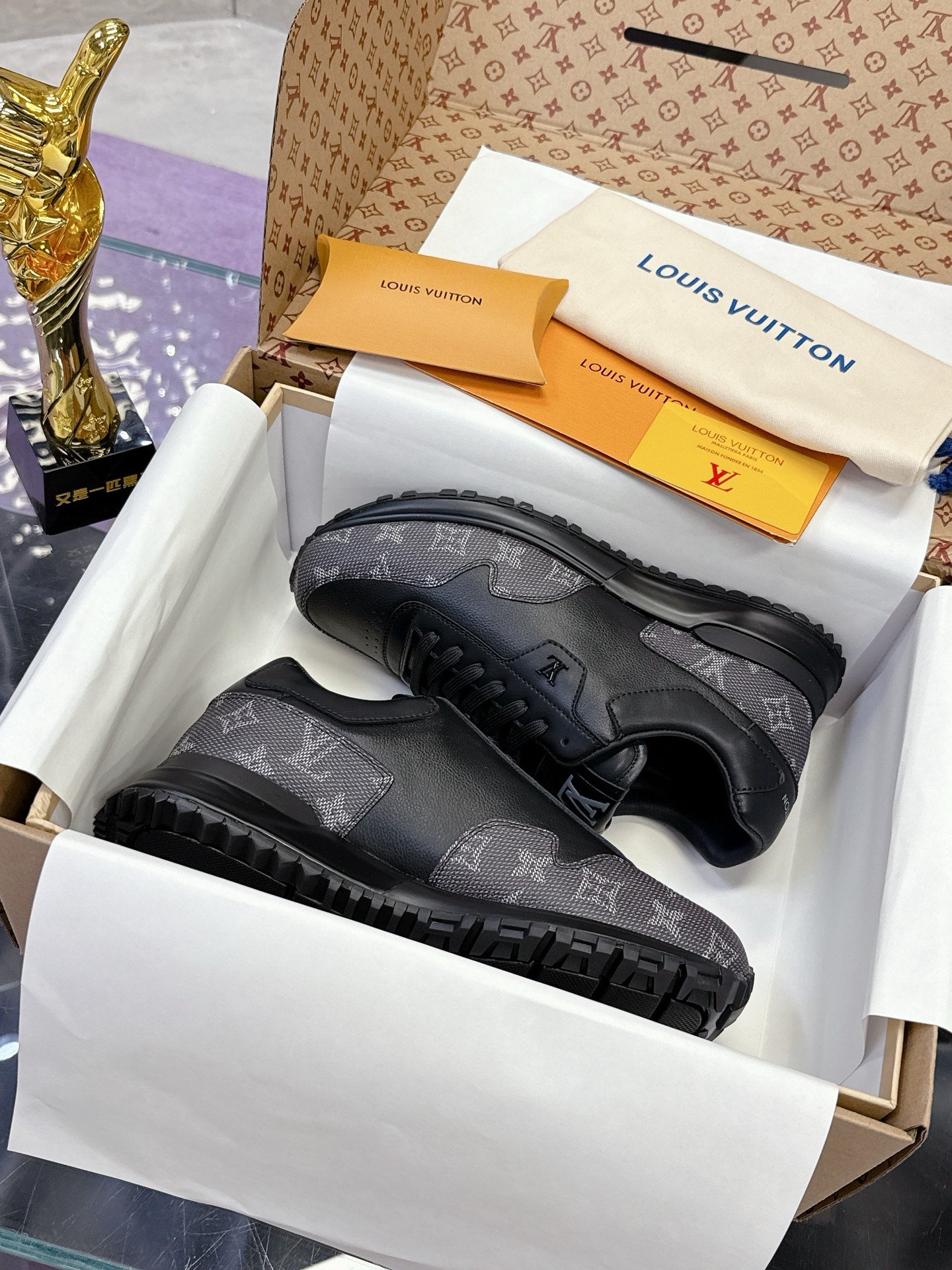 Louis Vuitton lace-up sneakers in dark gray/black monogram print, on gift box