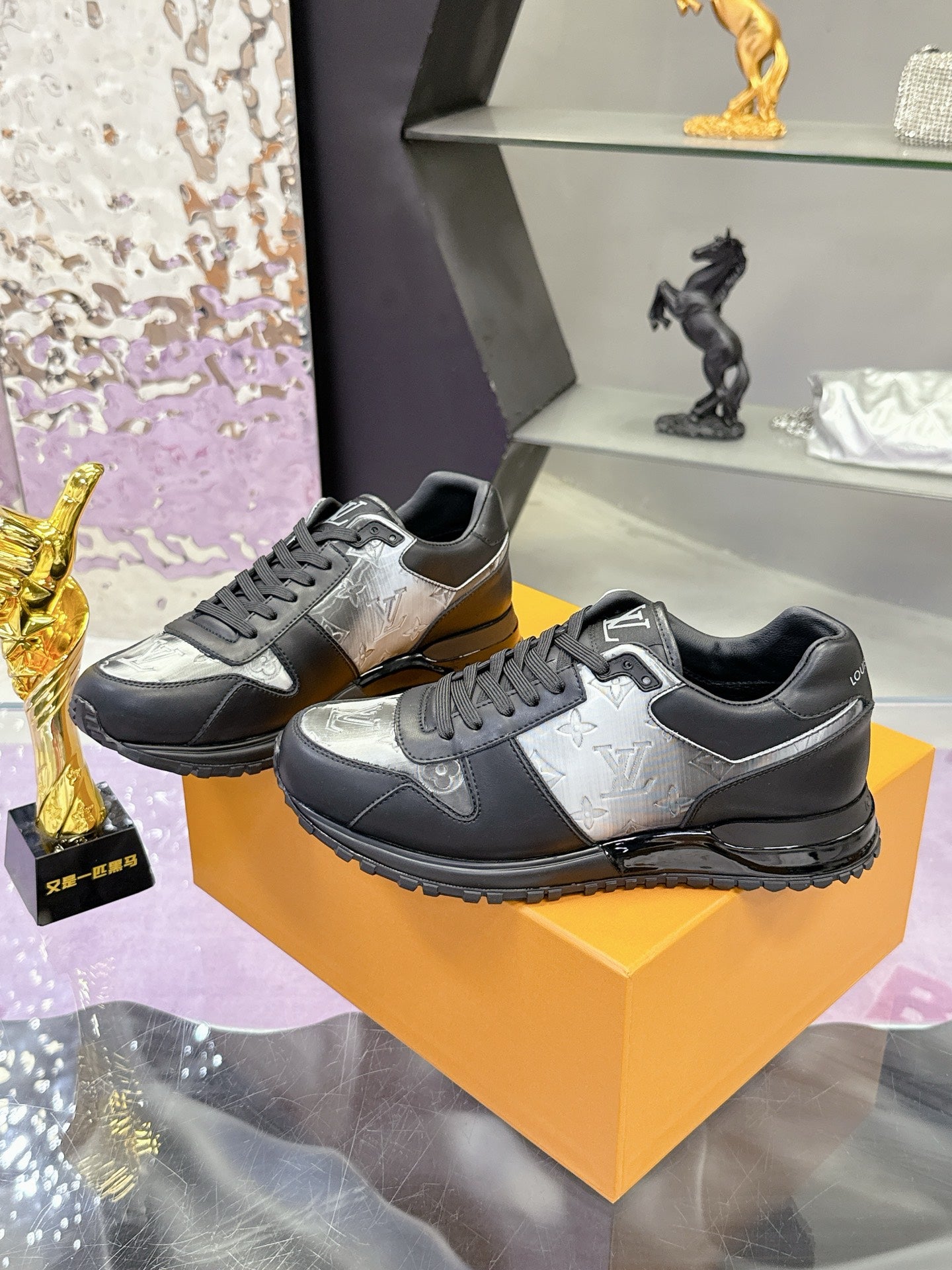 Louis Vuitton lace-up sneakers, dark sides with silver-toned panels, chunky tread sole.