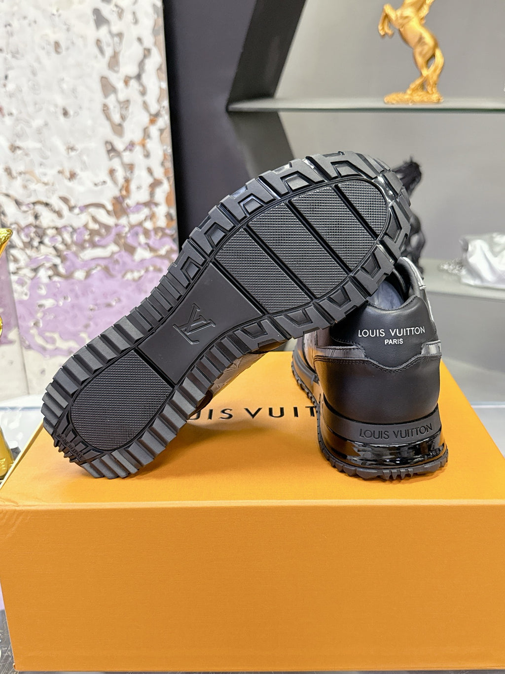 Louis Vuitton sneaker outsole and heel, textured tread on dark rubber sole.