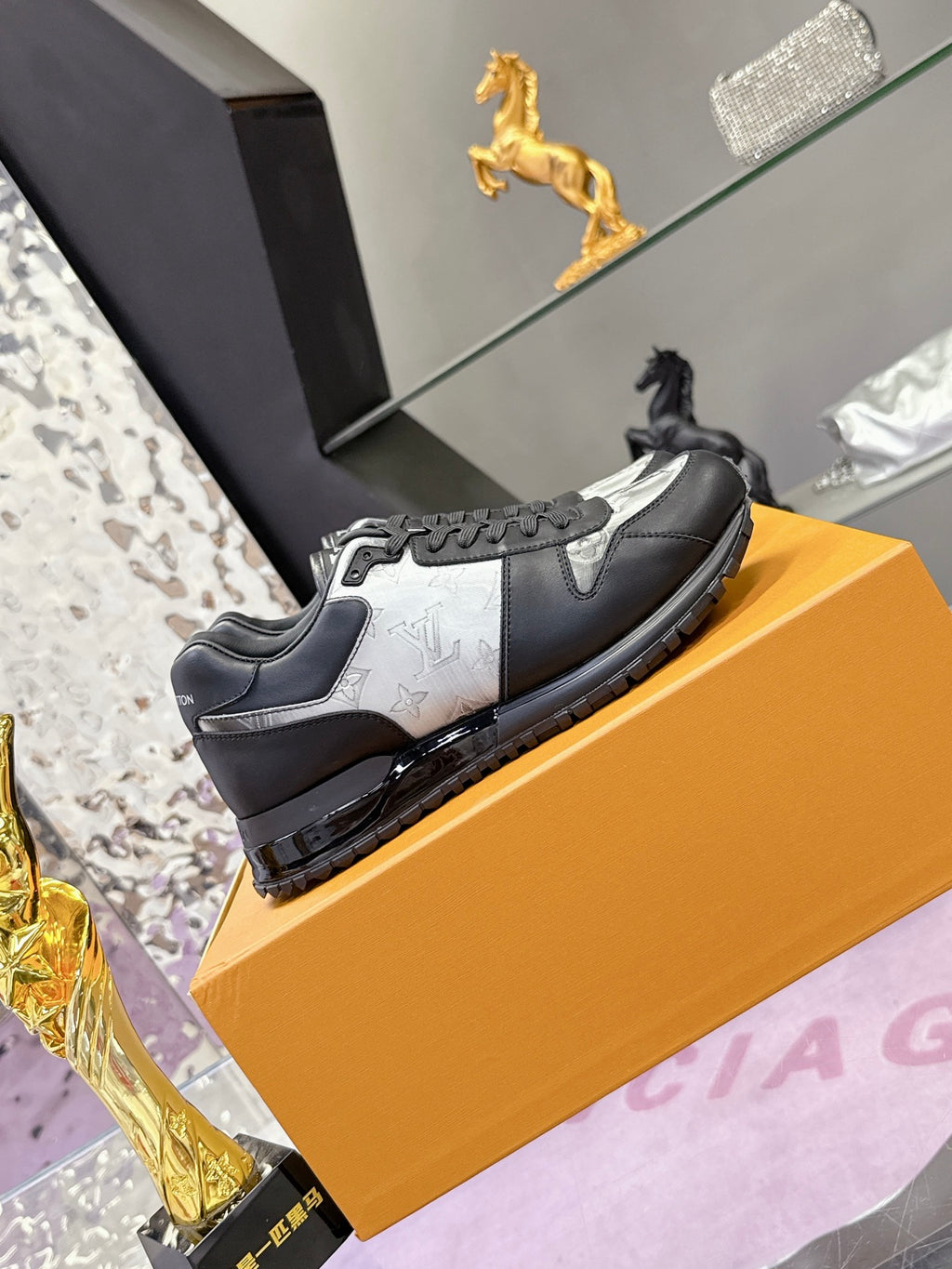 Louis Vuitton sneakers, dark leather with light monogram panel and lace-up front.