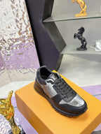 Louis Vuitton lace-up sneakers, dark leather with silver logo panel, low profile sole.