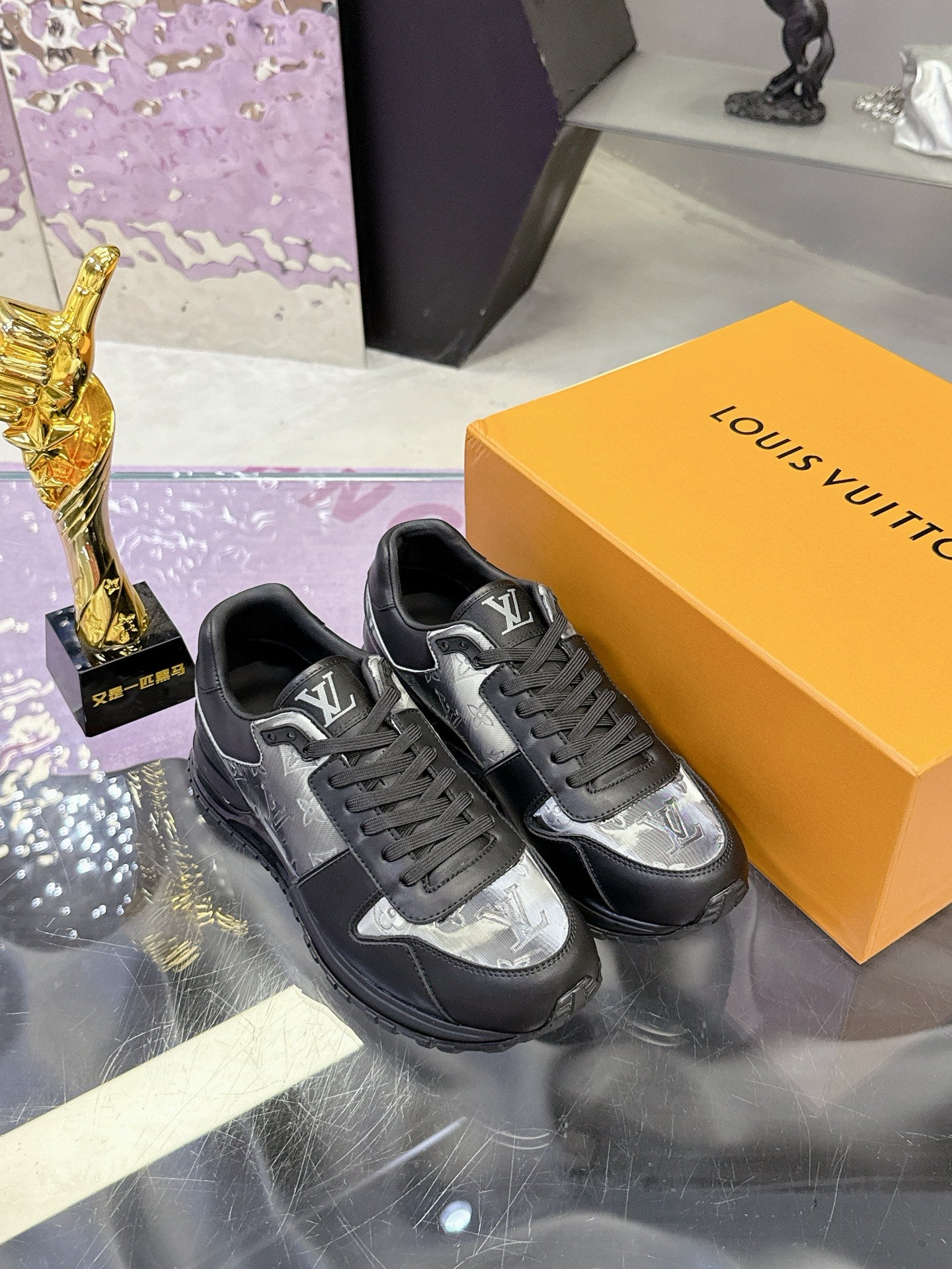 Louis Vuitton lace-up sneakers, dark leather with silver monogram quarter, on box.