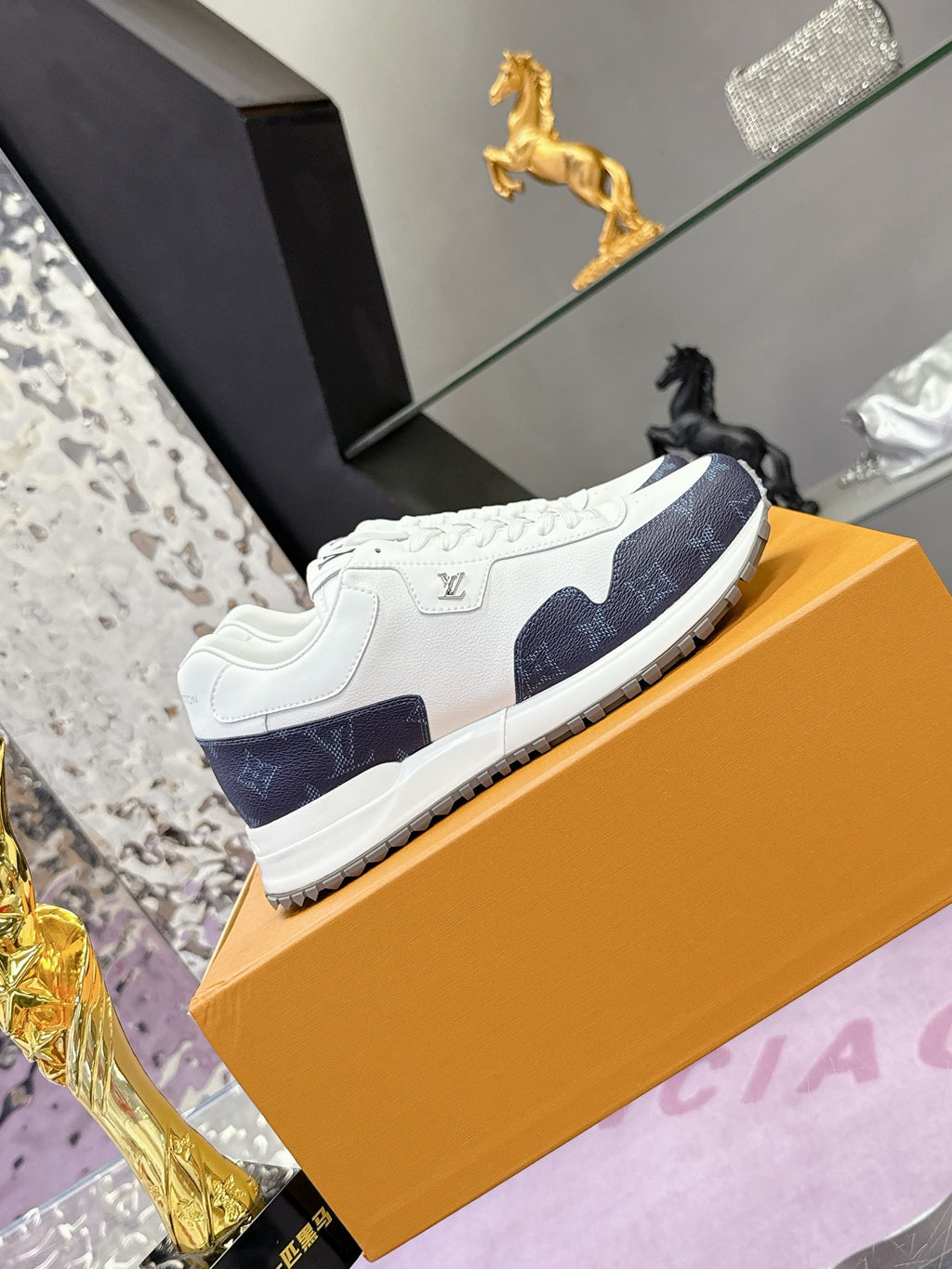 Louis Vuitton ladies sneakers, white upper with navy monogram side stripe and tread sole
