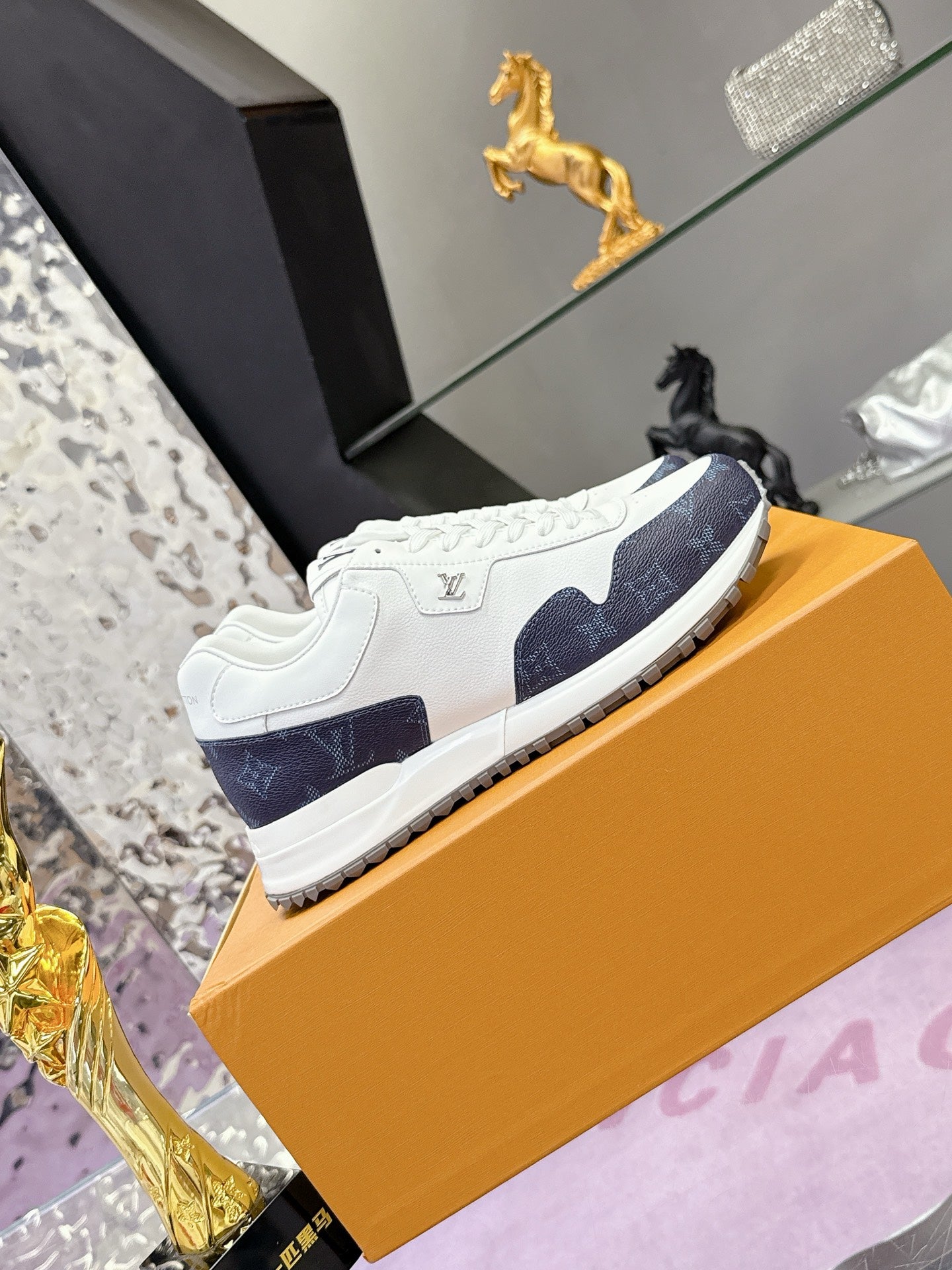 Louis Vuitton ladies sneakers, white upper with navy monogram side stripe and tread sole