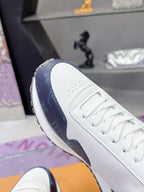 Louis Vuitton ladies sneaker side view, white leather with navy panel and lace-up closure
