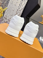 White women's sneakers viewed from the back with embossed logo and tread sole