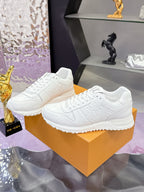 White women's low-top lace-up sneakers with monogram design and rubber sole