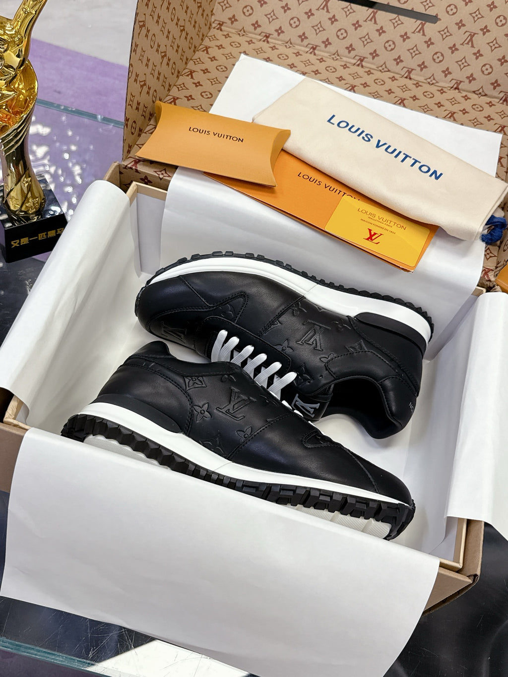 Louis Vuitton ladies black low-top sneakers, white laces and rubber sole