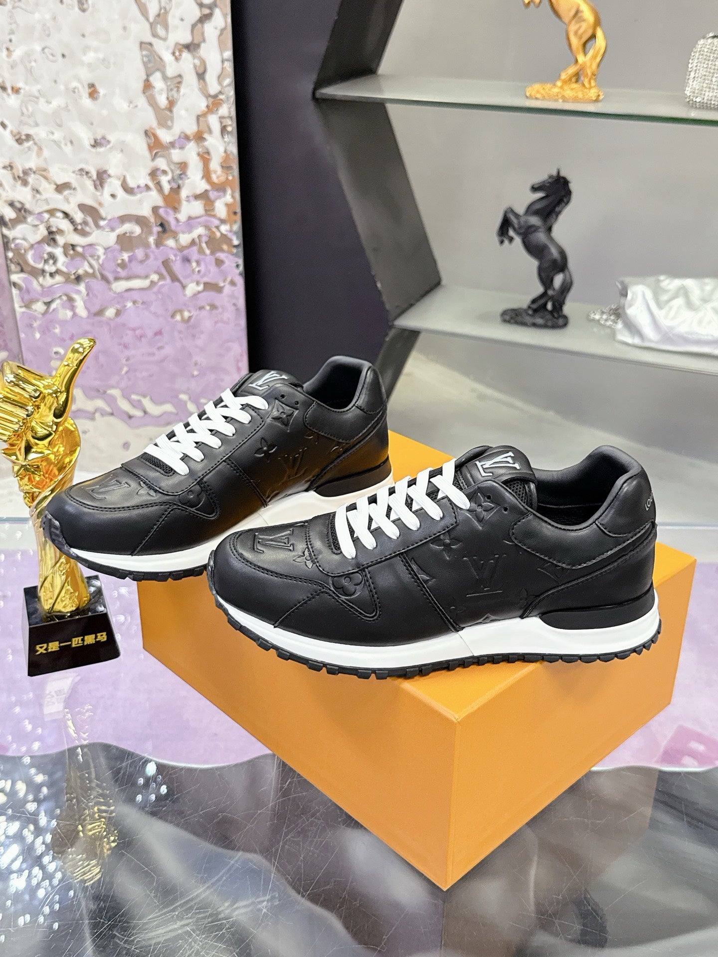 Louis Vuitton black leather sneakers, lace-up style with white tread sole
