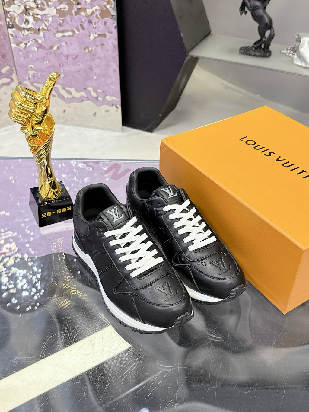 Louis Vuitton black sneakers with monogram detail, white laces and striped sole