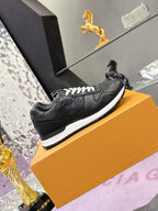 Louis Vuitton black low-top sneakers with embossed logos, white outsole trim