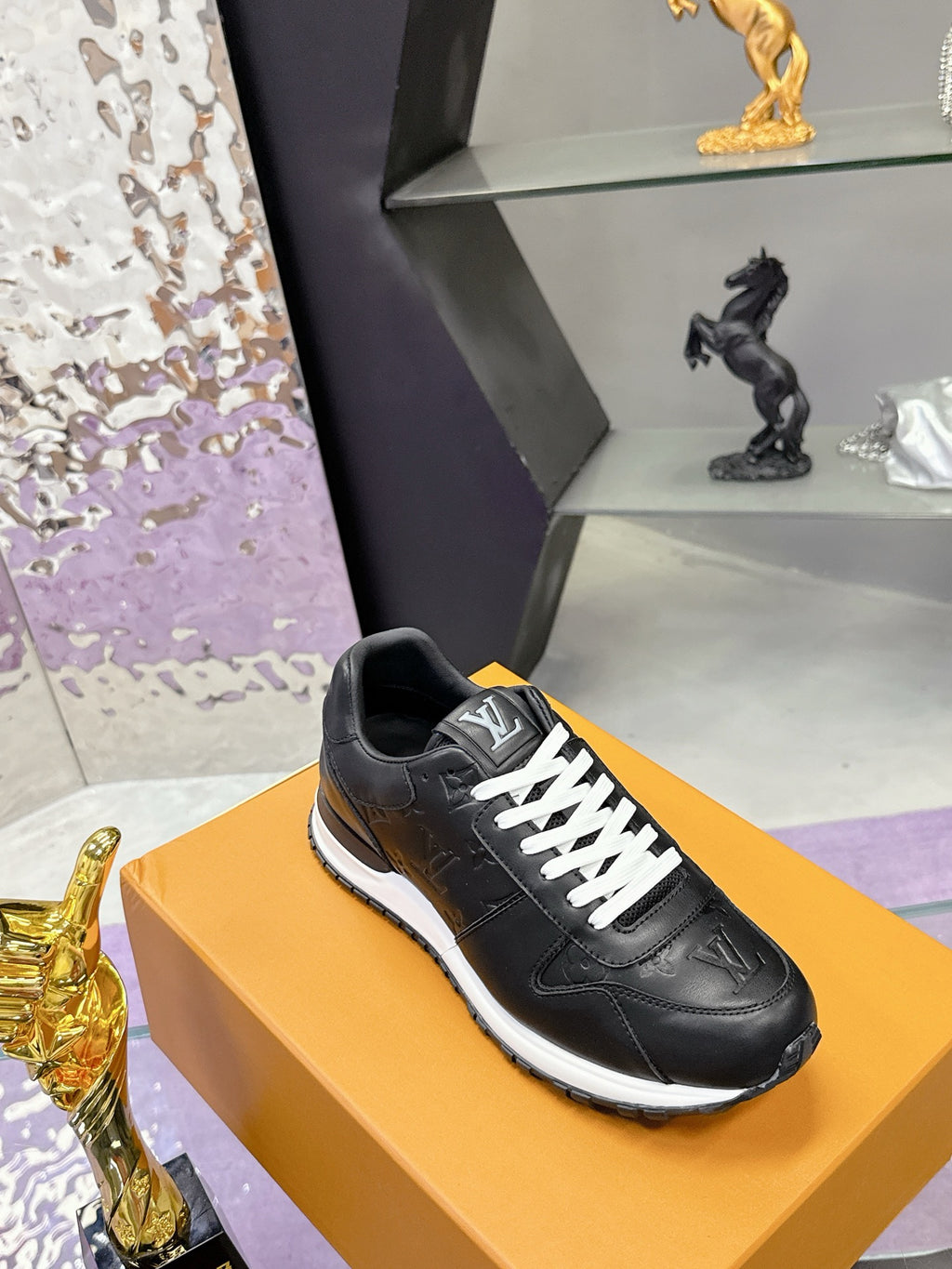 Louis Vuitton black low-top sneakers with side logo, white midsole trim