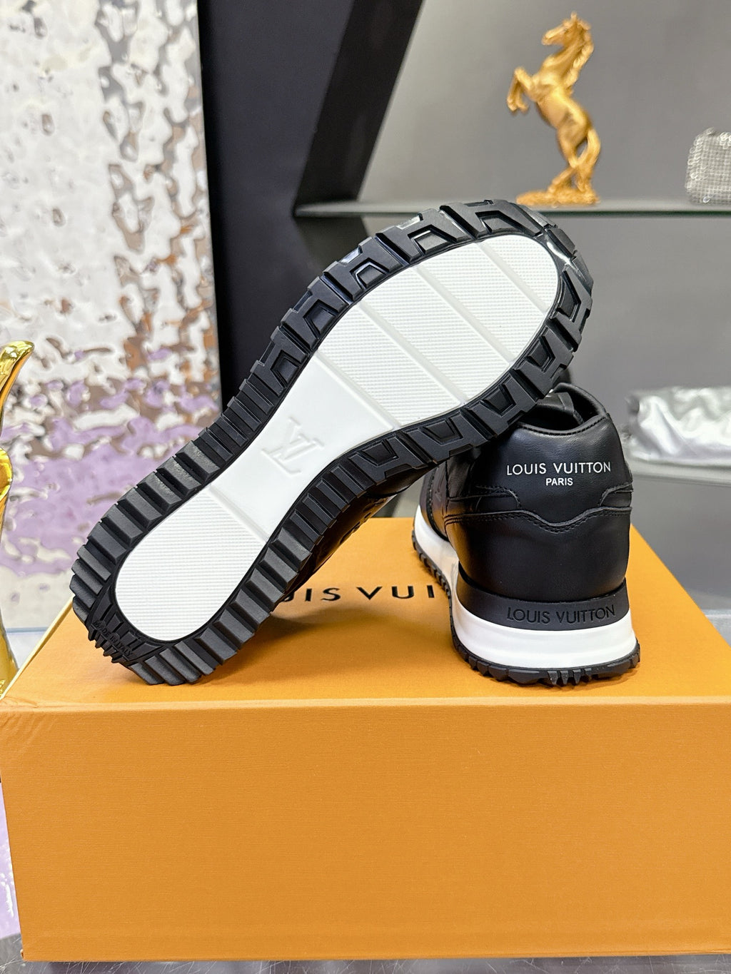Louis Vuitton sneakers heel and outsole view, black tread with white rubber