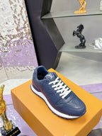 Blue leather low-top sneaker on orange box, white laces and textured upper.