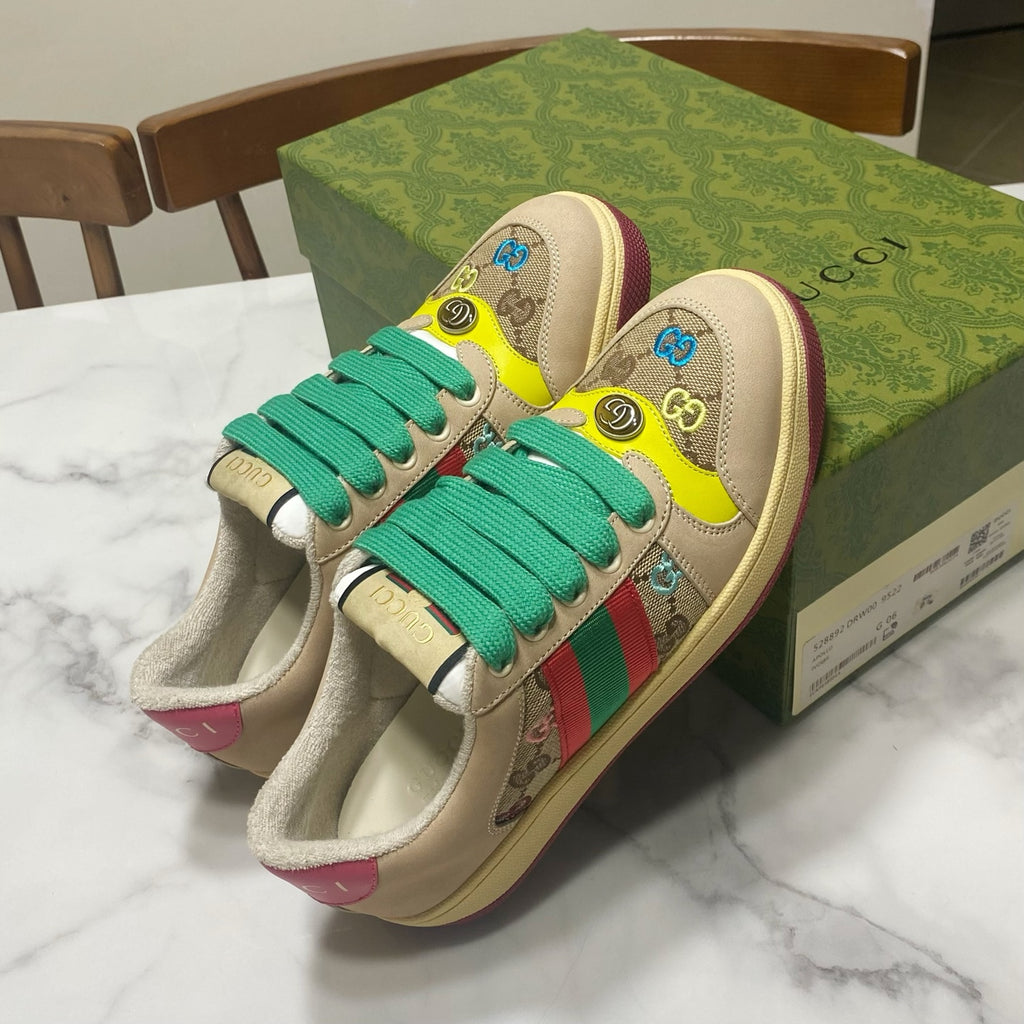 Gucci unisex sneakers on box, beige with teal laces, yellow toe, multicolor logo print