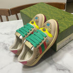 Gucci unisex sneakers on box, beige with teal laces, yellow toe, multicolor logo print
