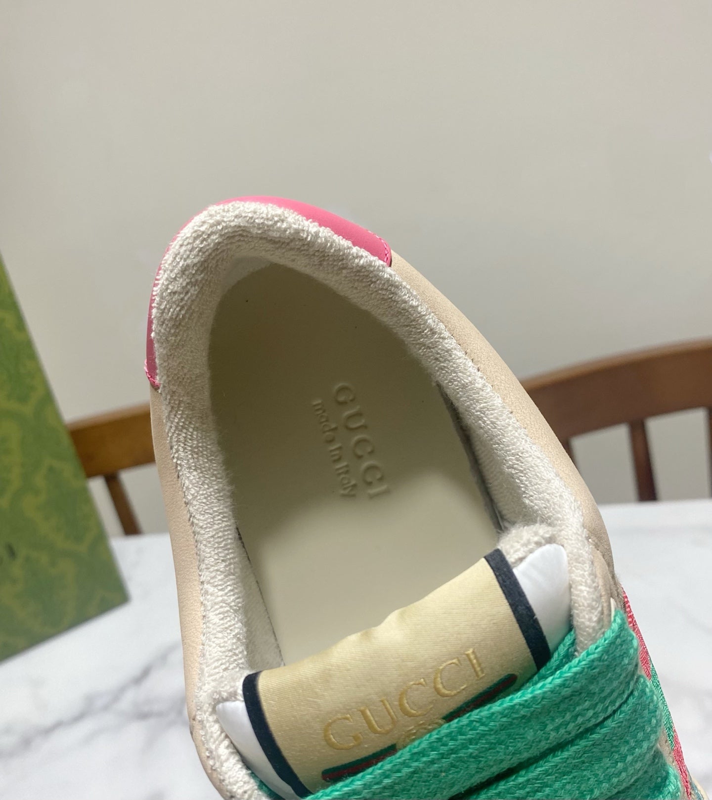 Gucci unisex sneaker heel, beige padded collar with dark trim and Gucci logo on lining