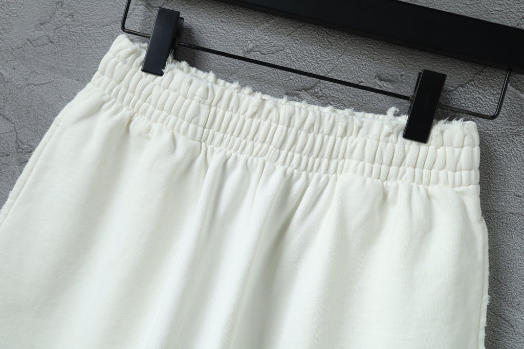 Balenciaga shorts front view with elastic waistband on a hanger