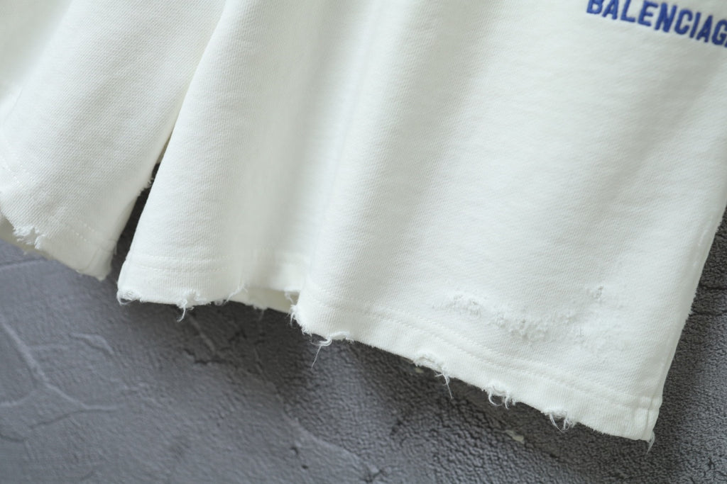 Balenciaga shorts with raw-edged hem and white cotton-like fabric
