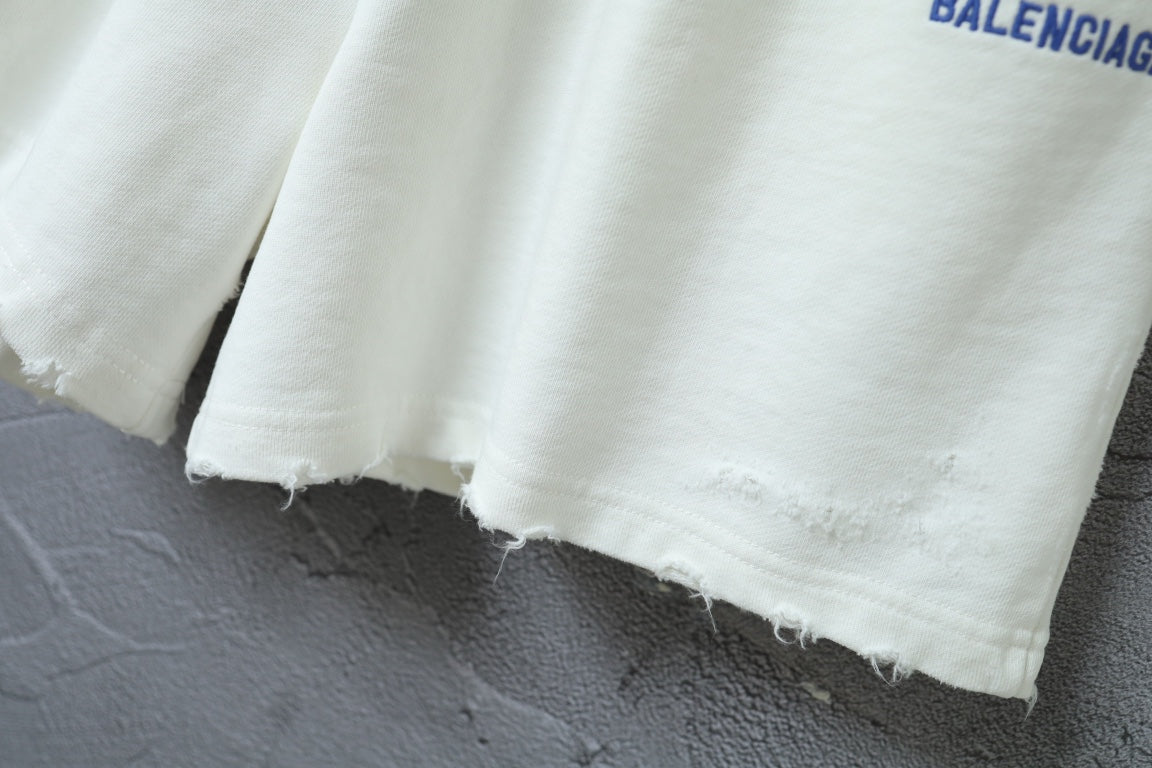 Balenciaga shorts with raw-edged hem and white cotton-like fabric