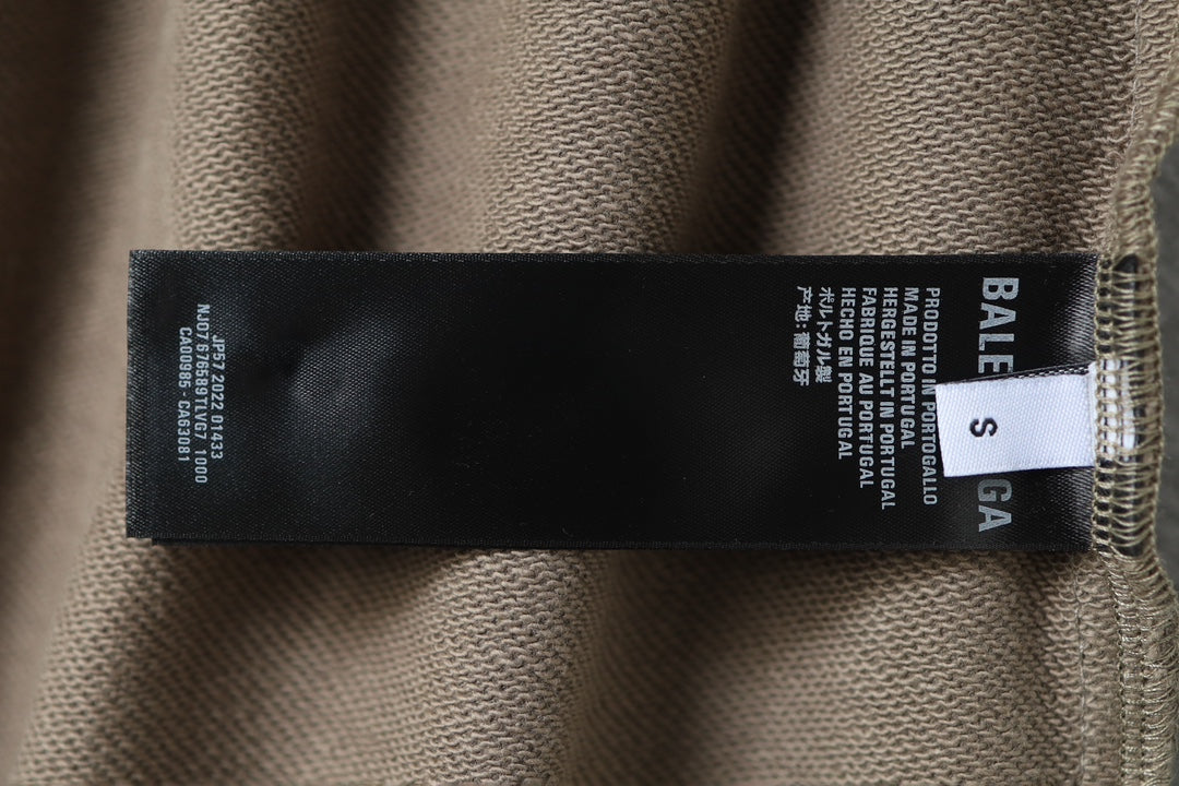 Balenciaga size label tag on taupe cotton shorts fabric