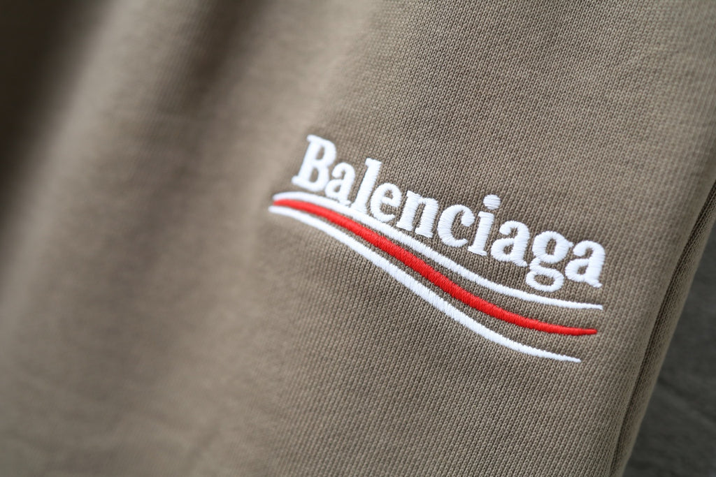 Balenciaga logo embroidery on taupe fabric with red and white stripe detail