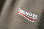 Balenciaga logo embroidery on taupe fabric with red and white stripe detail