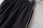 Black shorts with side stripe trim and elastic waistband
