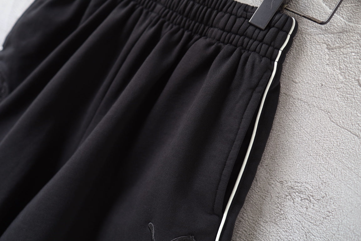 Black shorts with side stripe trim and elastic waistband