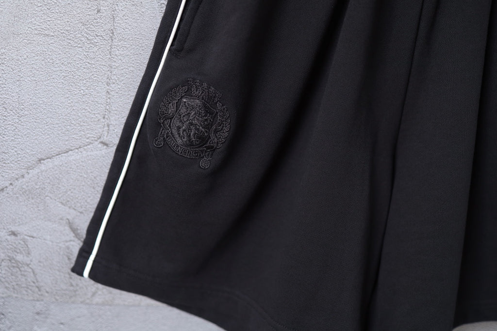 Black shorts front with embossed crest emblem and side stripe