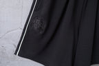 Black shorts front with embossed crest emblem and side stripe