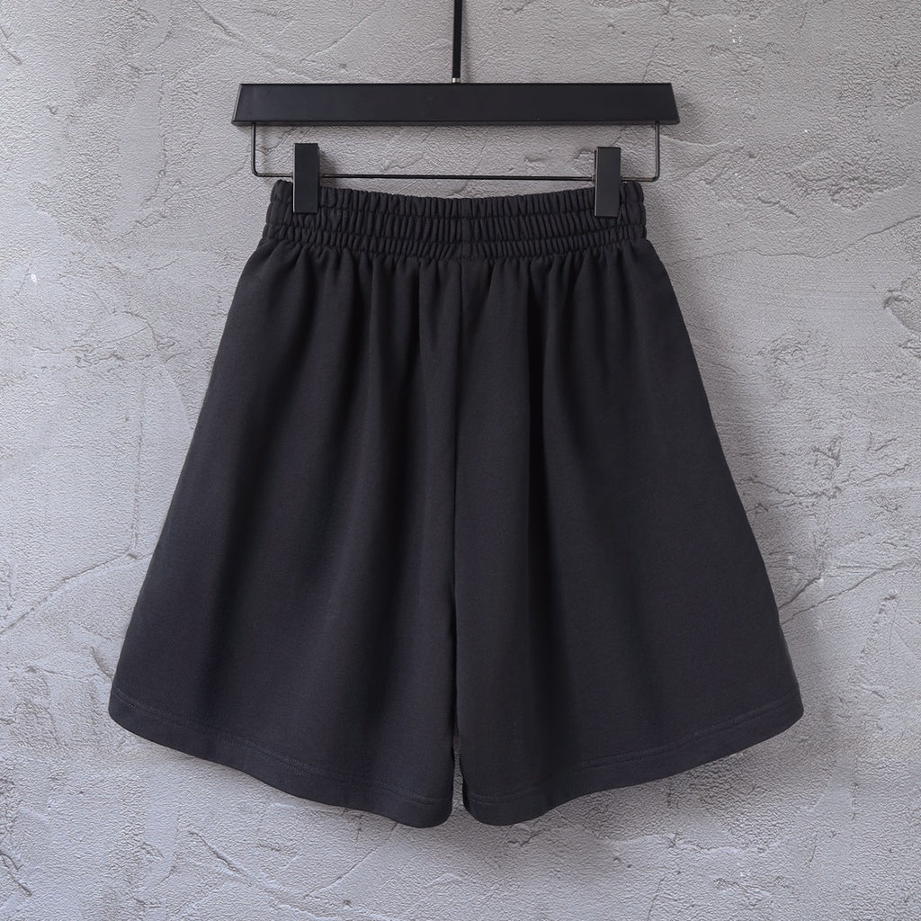 Black shorts with elastic waistband and side stripe, front view