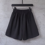 Black shorts with elastic waistband and side stripe, front view
