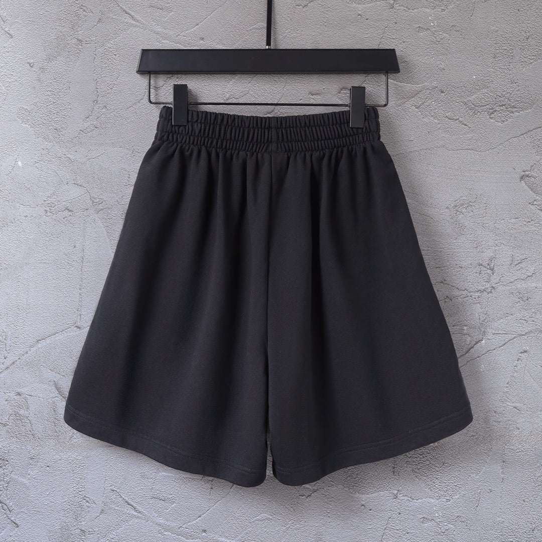 Black shorts with elastic waistband and side stripe, front view