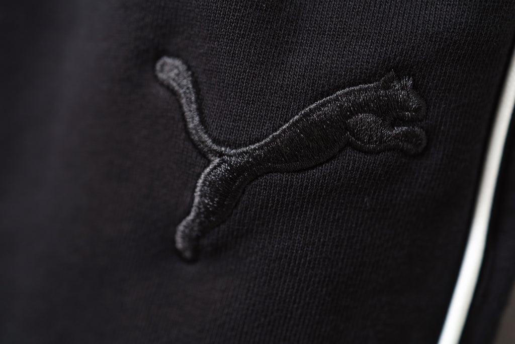 Close-up of Puma logo embroidery on black shorts