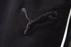 Close-up of Puma logo embroidery on black shorts