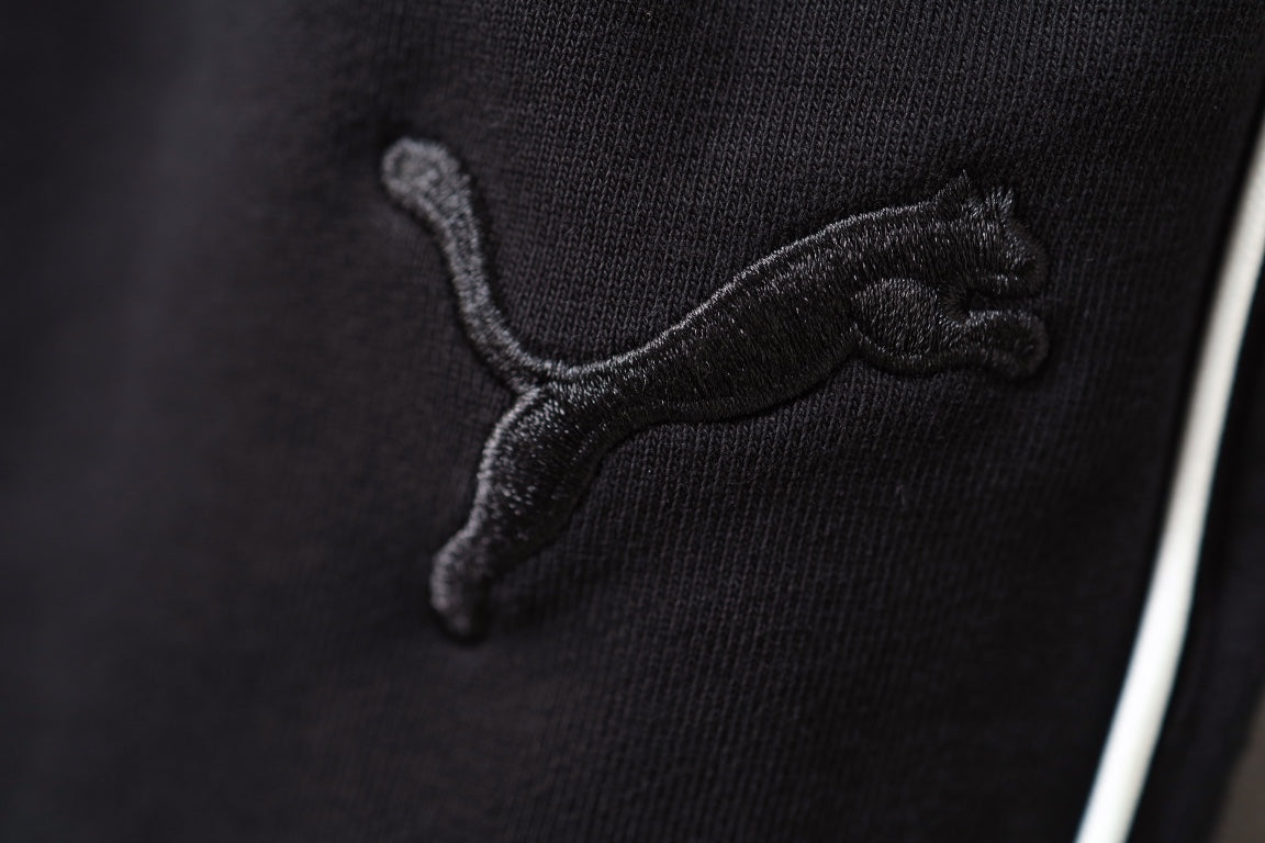 Close-up of Puma logo embroidery on black shorts
