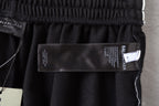 Balenciaga fabric label inside black shorts with size tag and branding