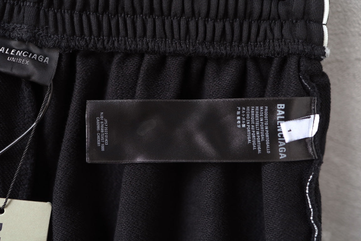 Balenciaga fabric label inside black shorts with size tag and branding
