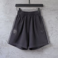 Black shorts with elastic waistband, side stripe, Puma logo and crest patch