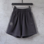 Black shorts with elastic waistband, side stripe, Puma logo and crest patch