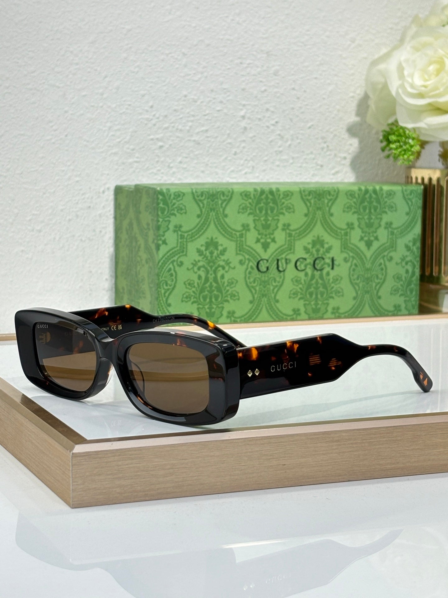 Gucci sunglasses with black frames and amber tinted lenses